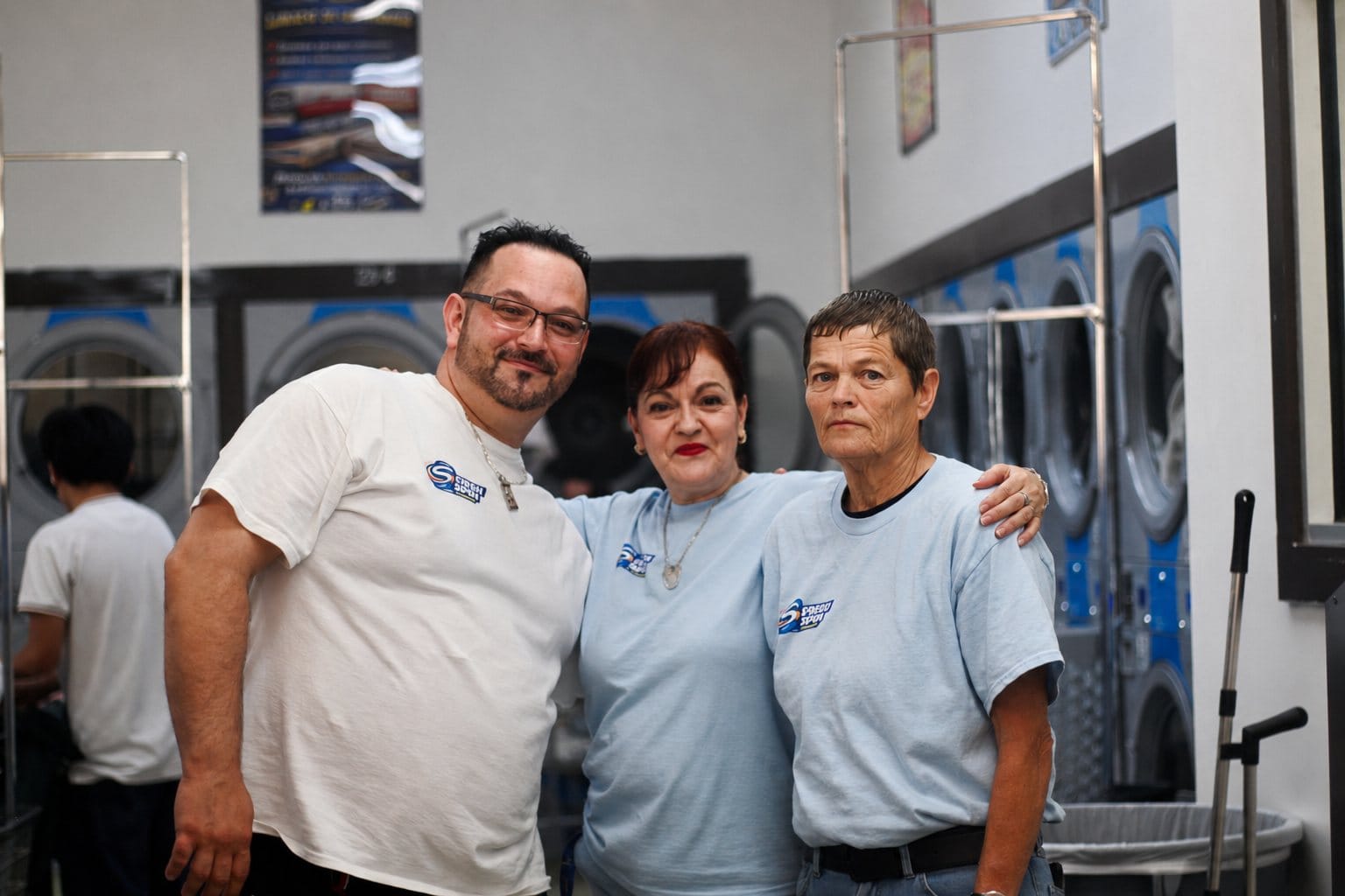 Fresh Spin Laundry team members stand together inside the Independence laundromat during Community Care Day.
